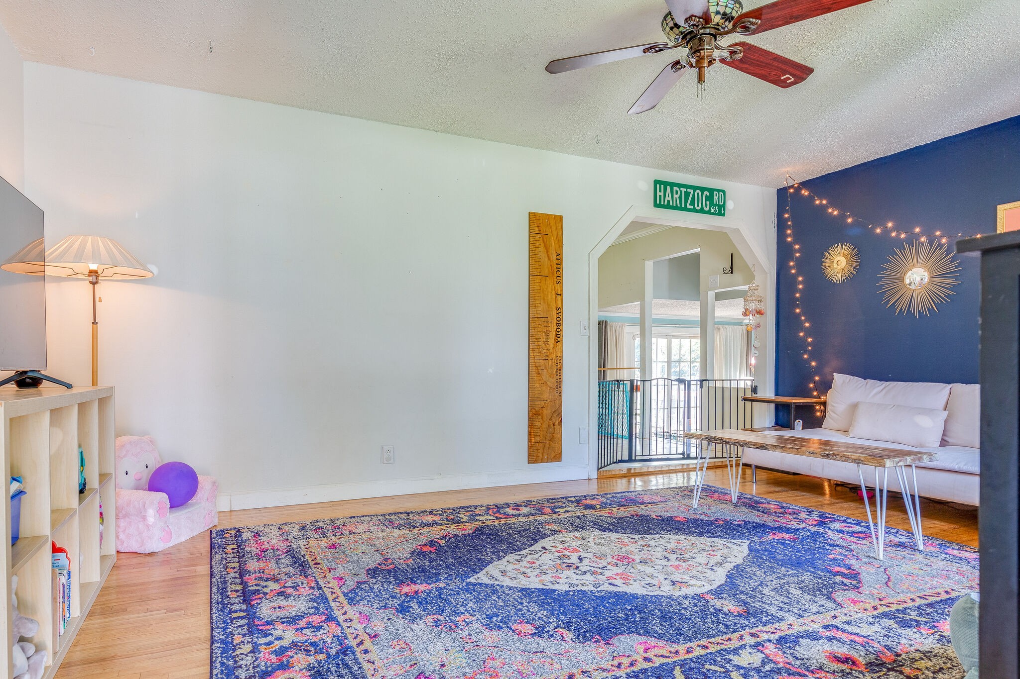 480 Rural Hill Road Nashville, TN 37217 - Photo 6 of 25 a living room with a dining table and paintings on the wall with wooden floor