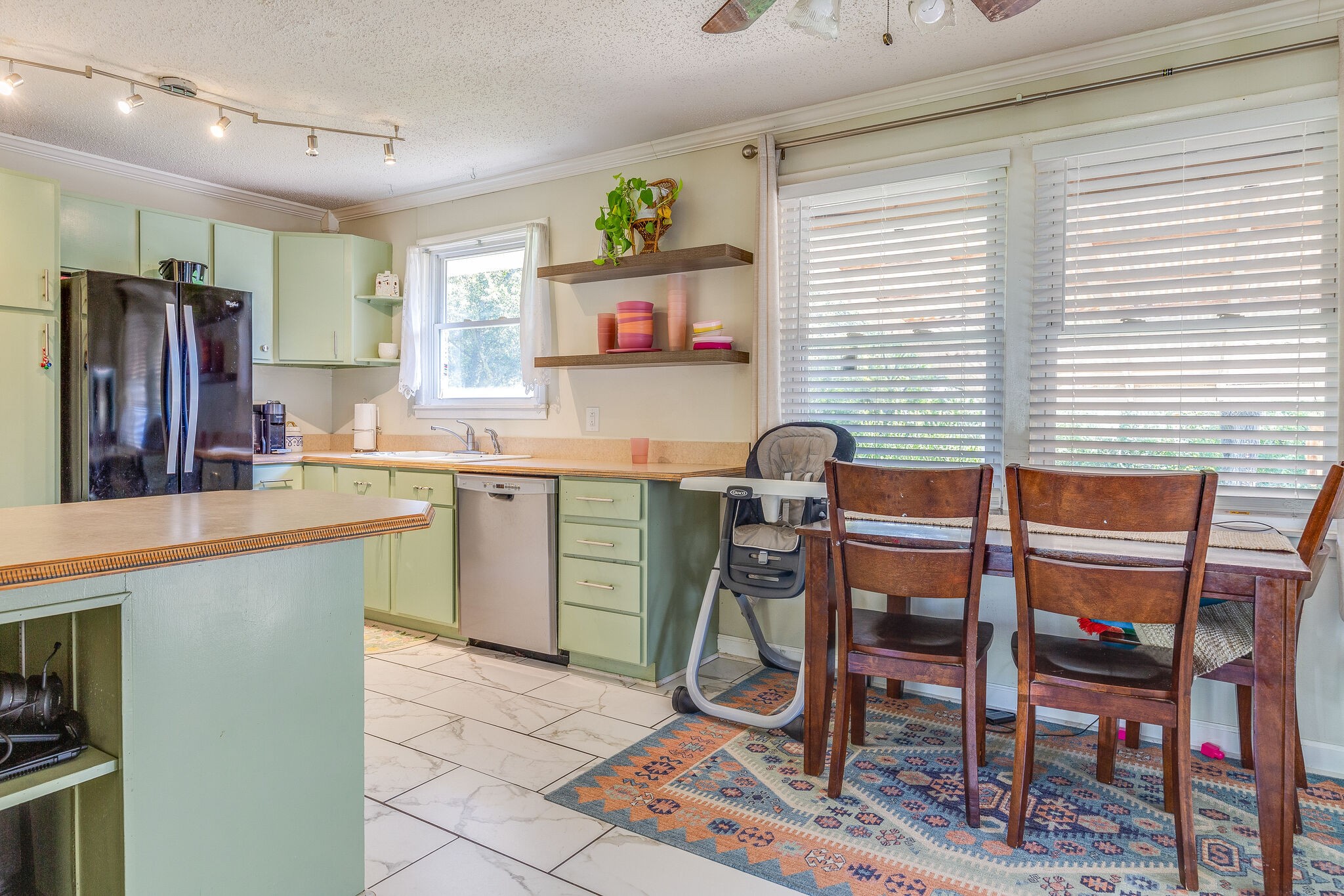 480 Rural Hill Road Nashville, TN 37217 - Photo 8 of 25 a kitchen with a dining table chairs and a refrigerator