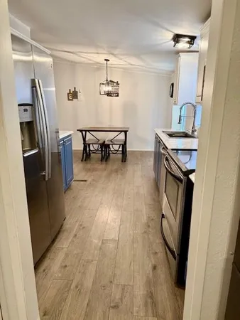 a kitchen with stainless steel appliances a stove refrigerator sink and microwave