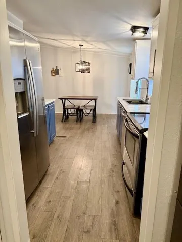 a kitchen with stainless steel appliances a stove refrigerator sink and microwave