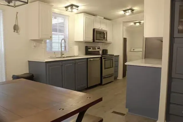 a kitchen with cabinets and stainless steel appliances