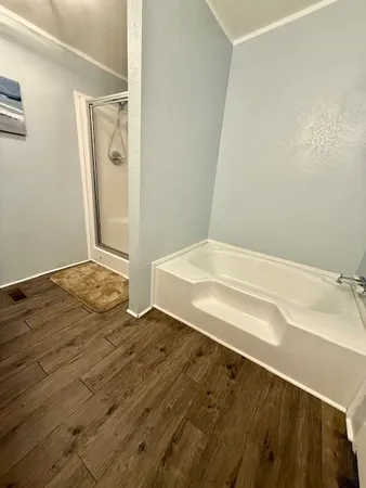 a bedroom with a bed and a ceiling fan