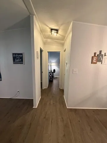 a utility room with wooden floor washer and dryer