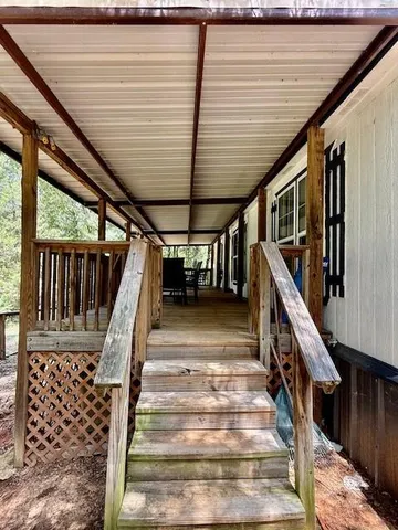 a view of a patio with a table chairs and wooden floor
