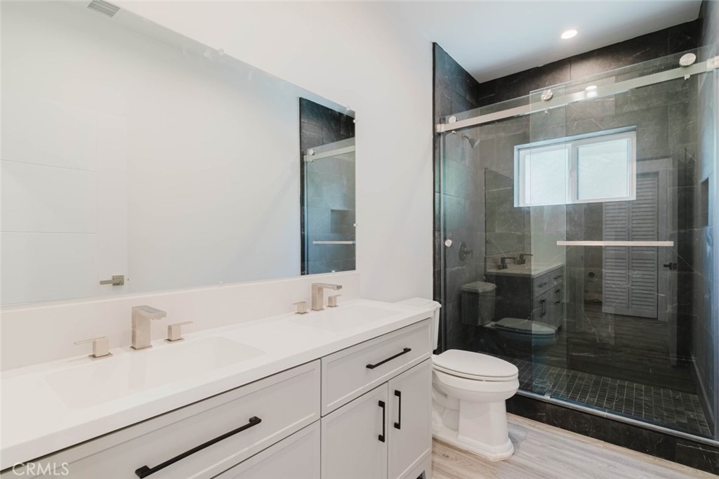 17846 Rinaldi Street Granada Hills, CA 91344 - Photo 23 of 34 a bathroom with a sink toilet and shower