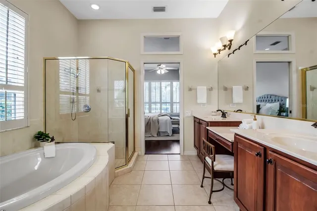a spacious bathroom with a granite countertop sink a toilet a mirror and shower