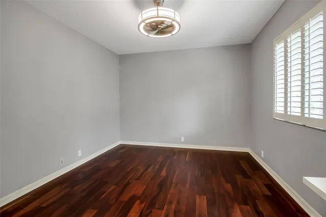 a view of a room with wooden floor and a window