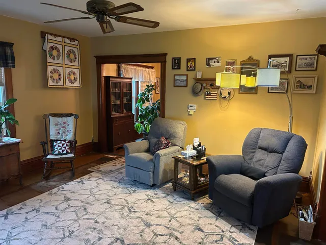 a living room with furniture and painting on the wall