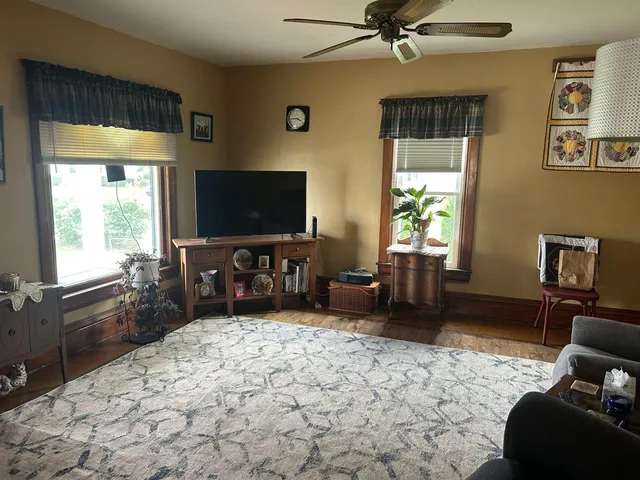 a bedroom with furniture and a flat screen tv