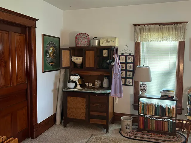 a living room with hard wood floors and a dresser