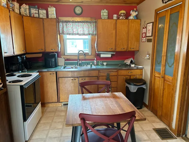 a kitchen with a sink appliances and cabinets
