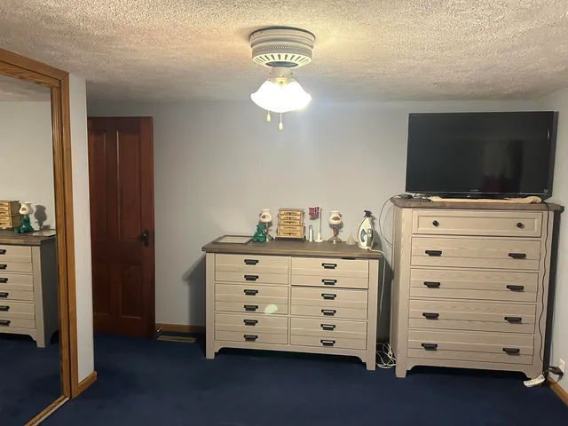 a room with a dresser and a flat screen tv