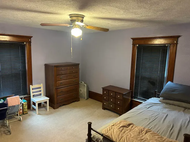 a bedroom with a bed and a dresser