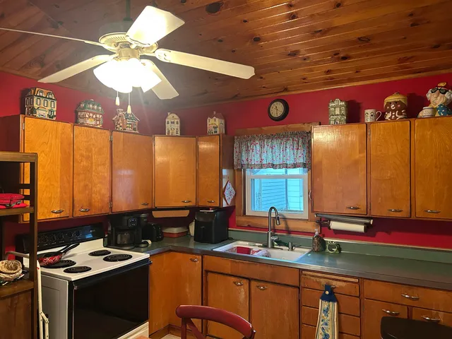 a kitchen with a sink cabinets and window