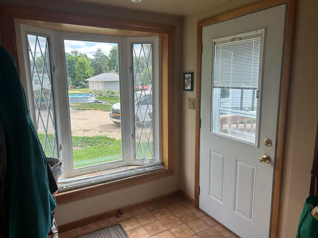 a view of a front door and bedroom from a window