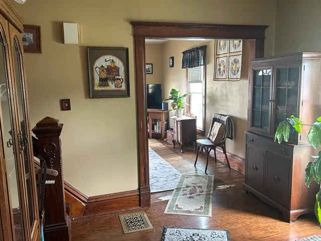 a living room with furniture and a potted plant