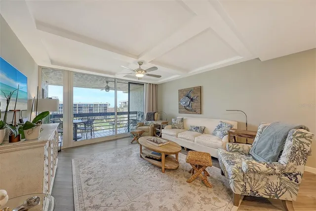 a dining room with furniture and a floor to ceiling window