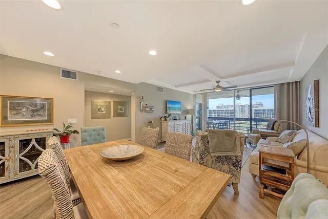 a kitchen with stainless steel appliances granite countertop a sink dishwasher stove and white cabinets with wooden floor