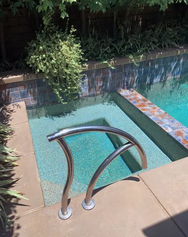 a view of a swimming pool with a yard