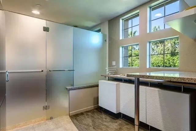 a kitchen with stainless steel appliances granite countertop a sink and a refrigerator