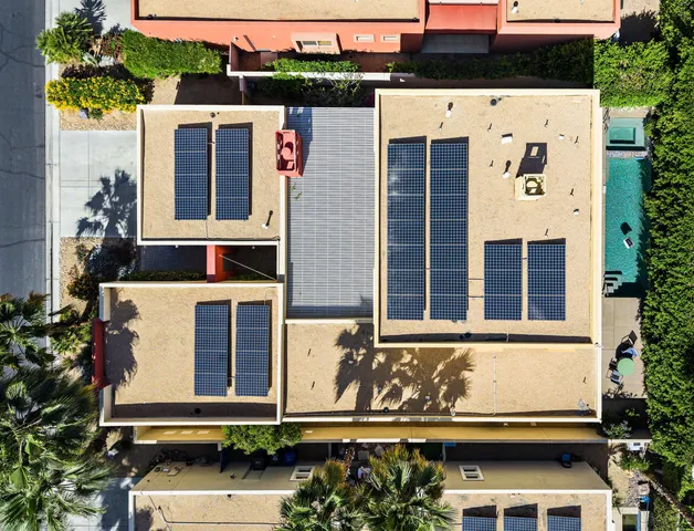 an aerial view of a house with a yard