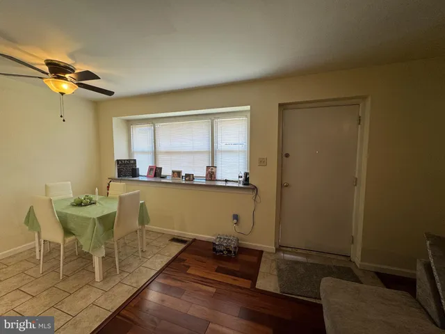 a view of a dining room with furniture and a window