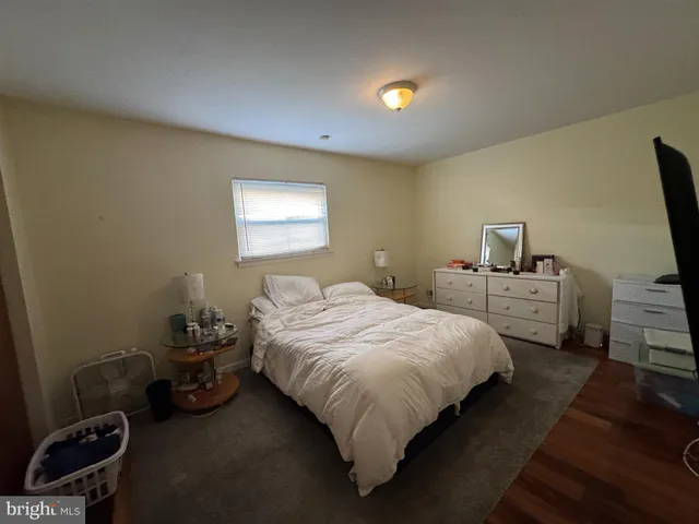 a bedroom with a bed and a tv