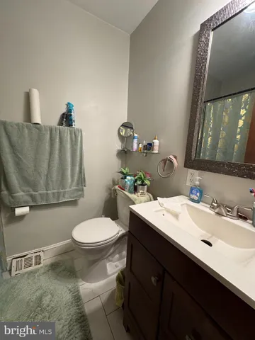 a bathroom with a sink toilet and mirror