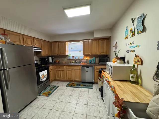 a kitchen with a refrigerator a stove a sink dishwasher and a refrigerator