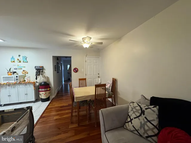 a living room with furniture and a dining table