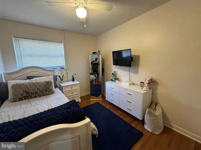 a bedroom with furniture and a flat screen tv