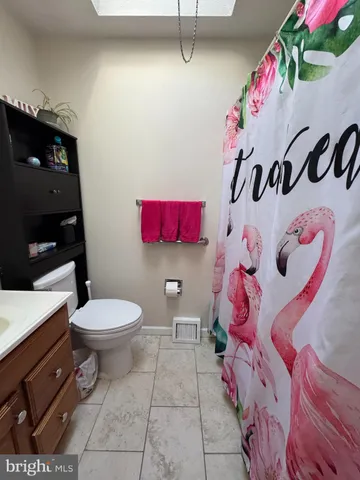 a bathroom with a sink toilet and a shower curtain