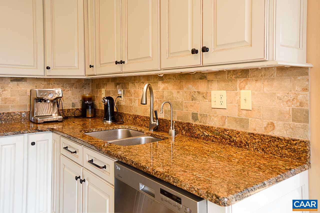 6688 Amicus Road Ruckersville, VA 22968 - Photo 15 of 43 a kitchen with granite countertop a sink and white cabinets