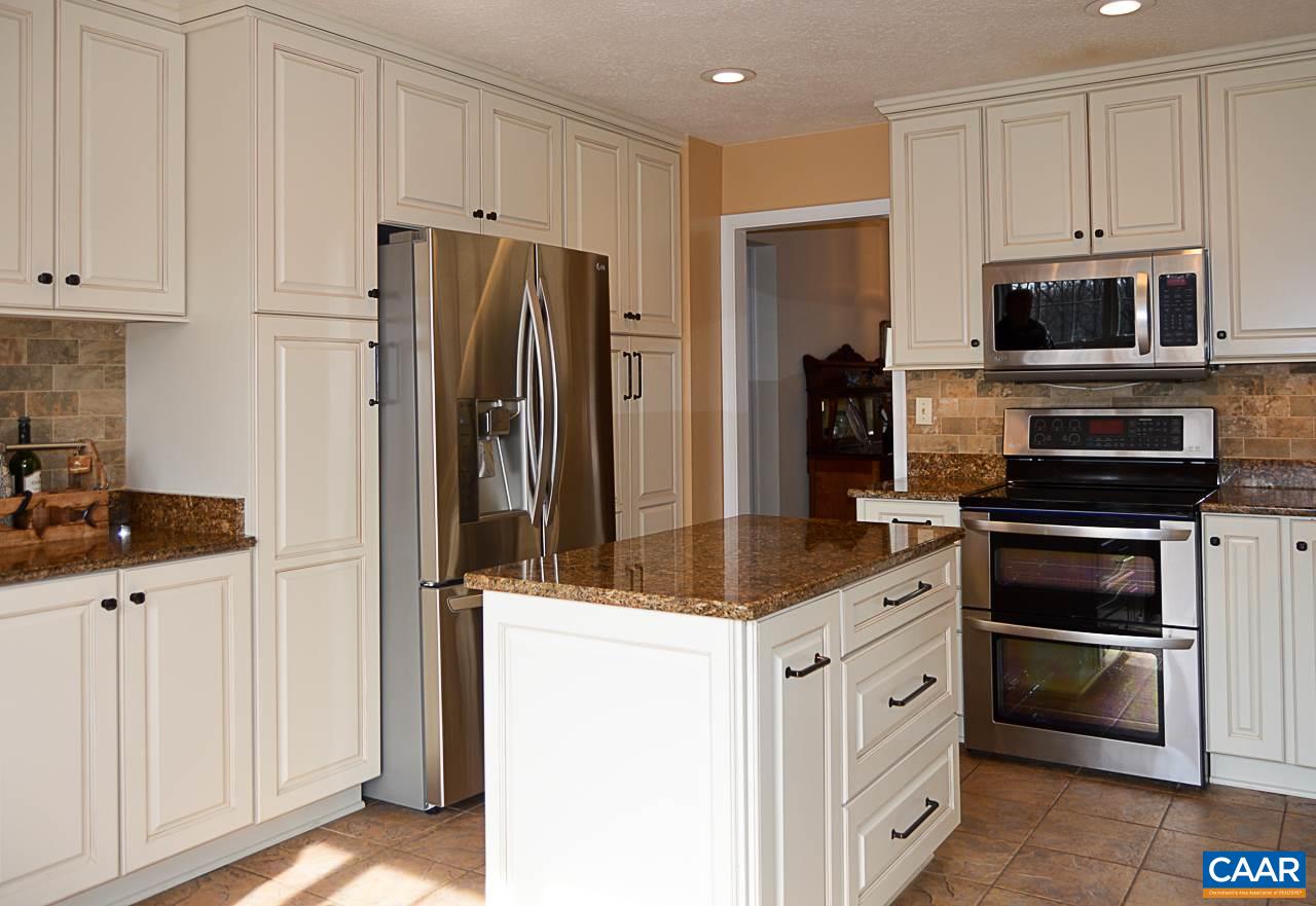 6688 Amicus Road Ruckersville, VA 22968 - Photo 17 of 43 a kitchen with white cabinets and stainless steel appliances