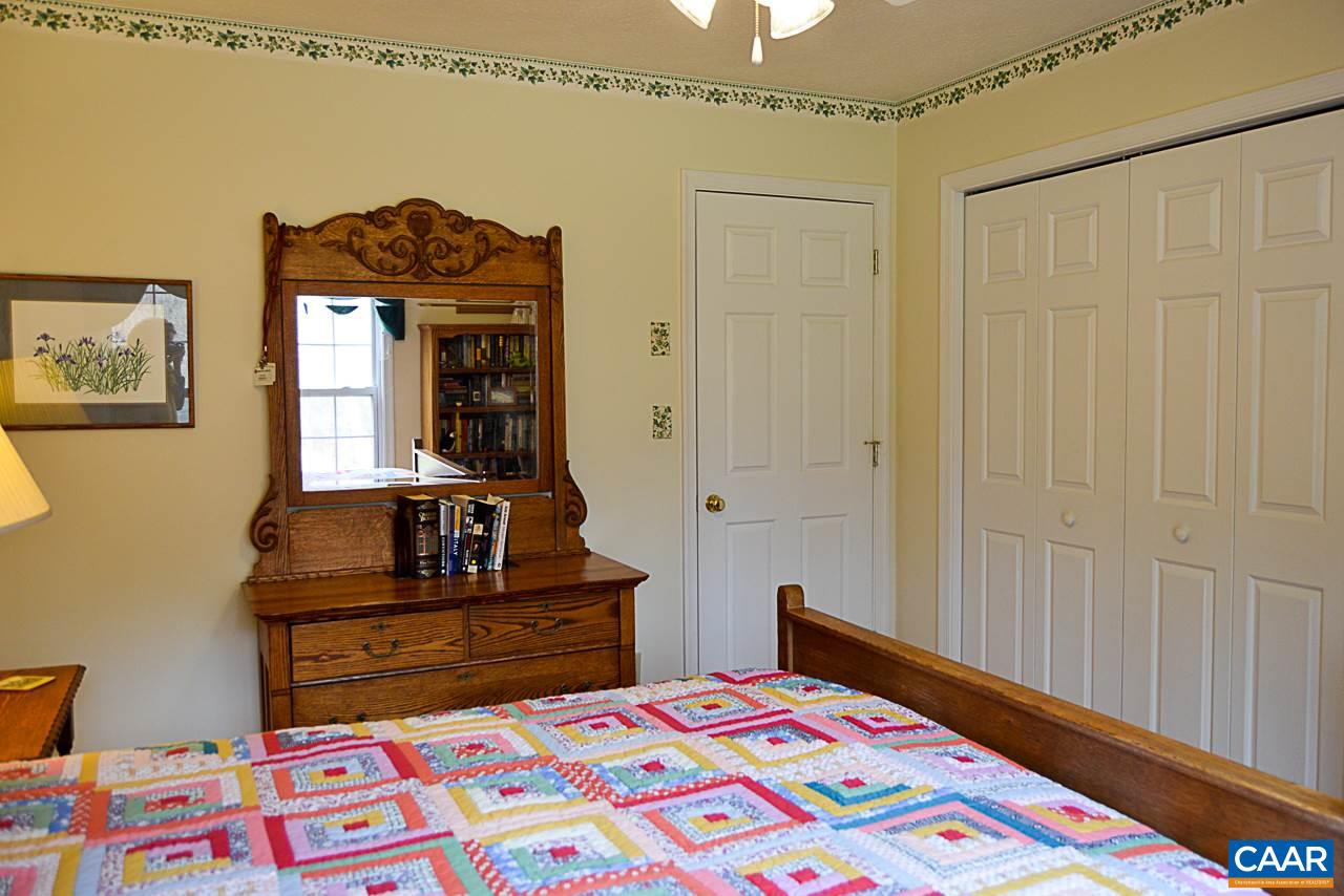 6688 Amicus Road Ruckersville, VA 22968 - Photo 23 of 43 a bedroom with a bed and a dresser in it