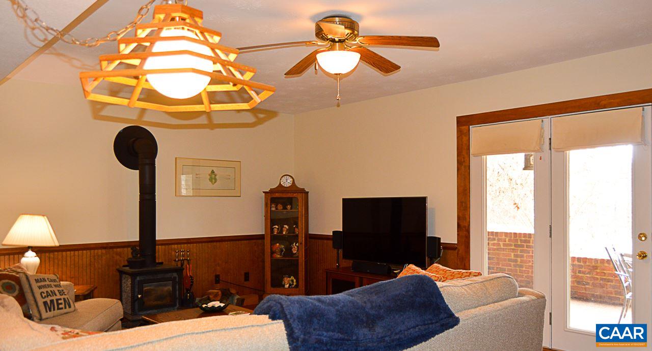6688 Amicus Road Ruckersville, VA 22968 - Photo 27 of 43 a living room with furniture a flat screen tv and a chandelier
