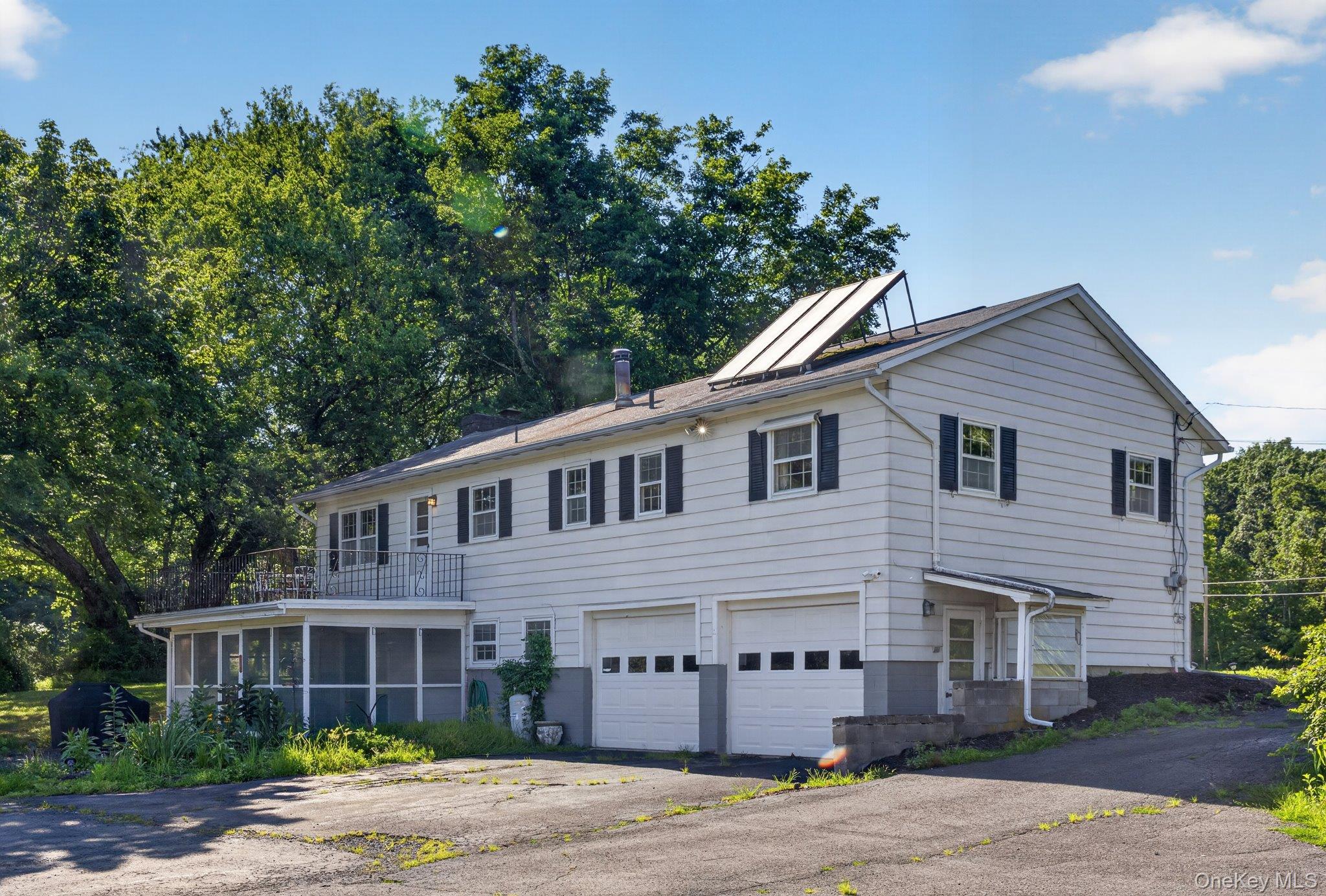 315 Pine Bush Road Stone Ridge, NY 12484 - Photo 28 of 32 a front view of a house with a garden