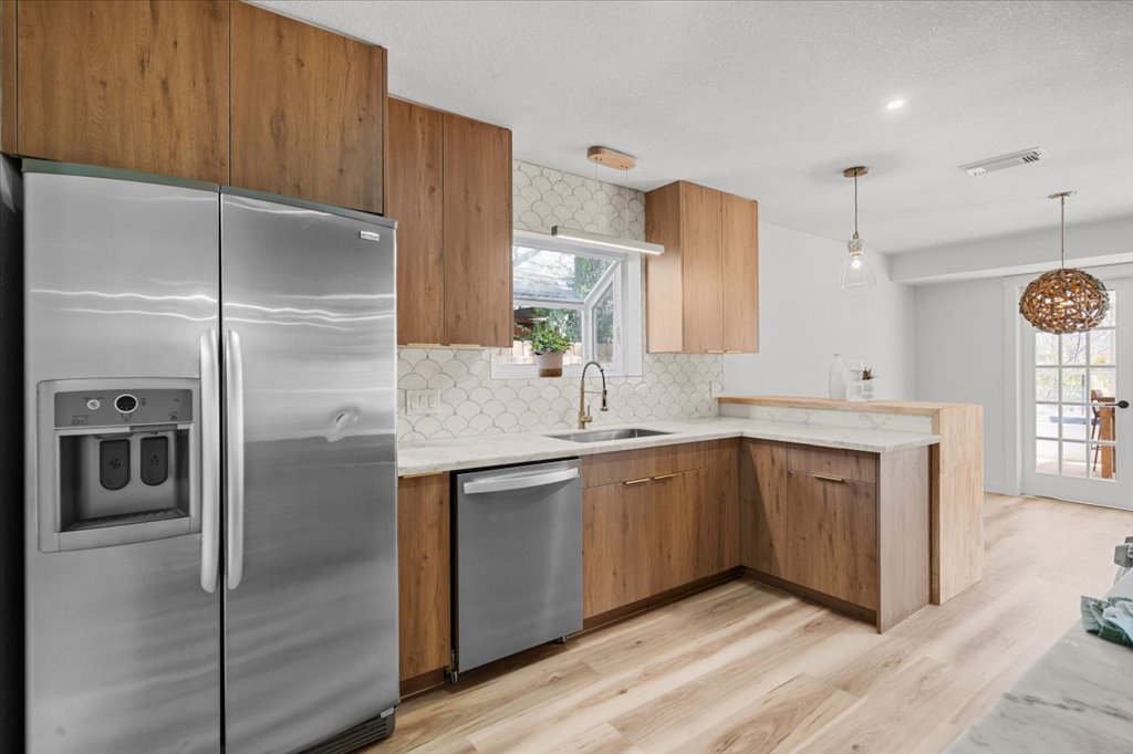 9223 Independence Loop Austin, TX 78748 - Photo 12 of 37 a kitchen with stainless steel appliances granite countertop a refrigerator and a sink