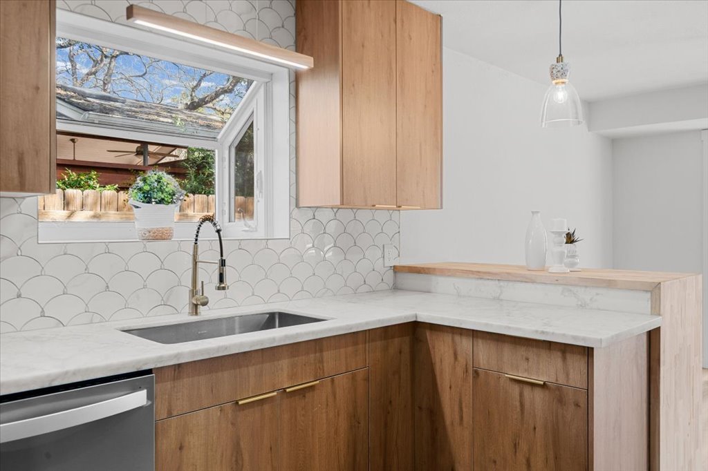 9223 Independence Loop Austin, TX 78748 - Photo 13 of 37 a kitchen with a sink and cabinets