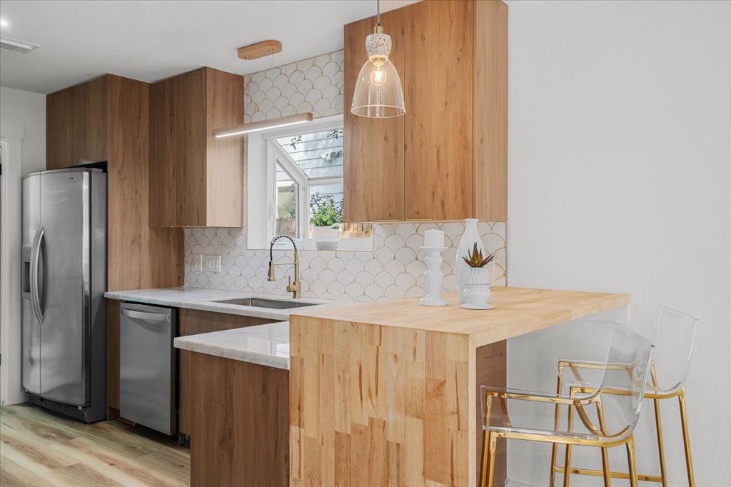 9223 Independence Loop Austin, TX 78748 - Photo 16 of 37 a kitchen with a sink a refrigerator and cabinets