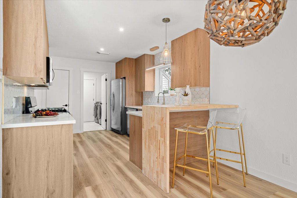 9223 Independence Loop Austin, TX 78748 - Photo 17 of 37 a kitchen with stainless steel appliances a refrigerator and a stove top oven