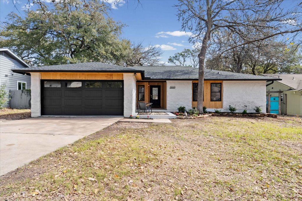 9223 Independence Loop Austin, TX 78748 - Photo 2 of 37 a view of a house with a yard and garage
