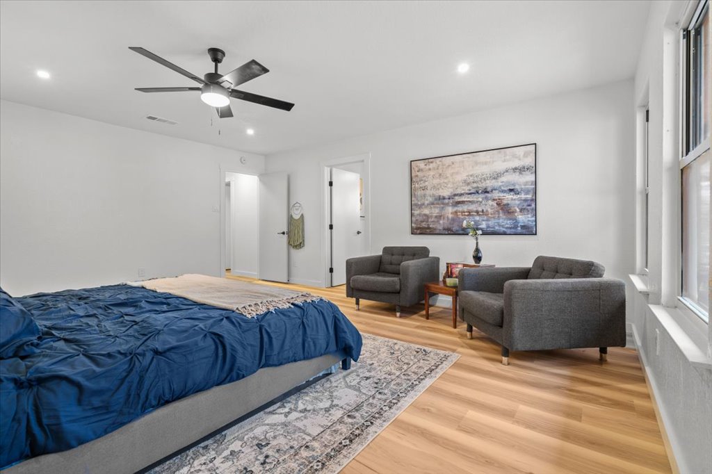 9223 Independence Loop Austin, TX 78748 - Photo 21 of 37 a spacious bedroom with a bed a couch and a window