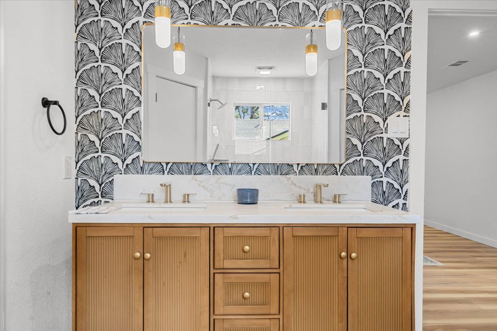 9223 Independence Loop Austin, TX 78748 - Photo 22 of 37 a bathroom with a granite countertop sink and a mirror