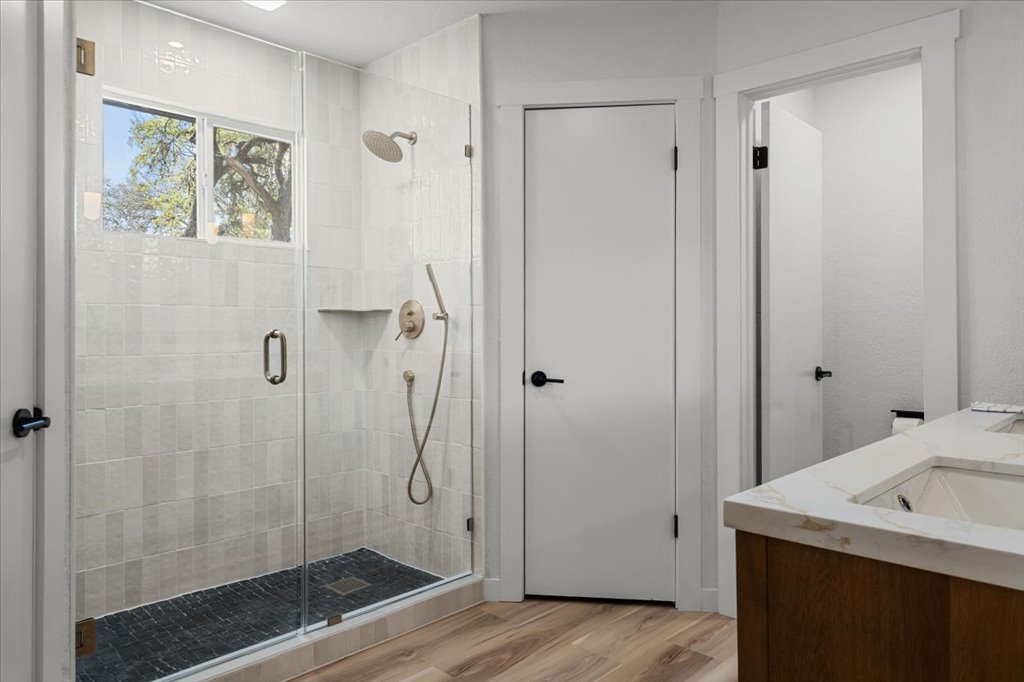 9223 Independence Loop Austin, TX 78748 - Photo 24 of 37 a bathroom with a granite countertop sink a shower and a mirror