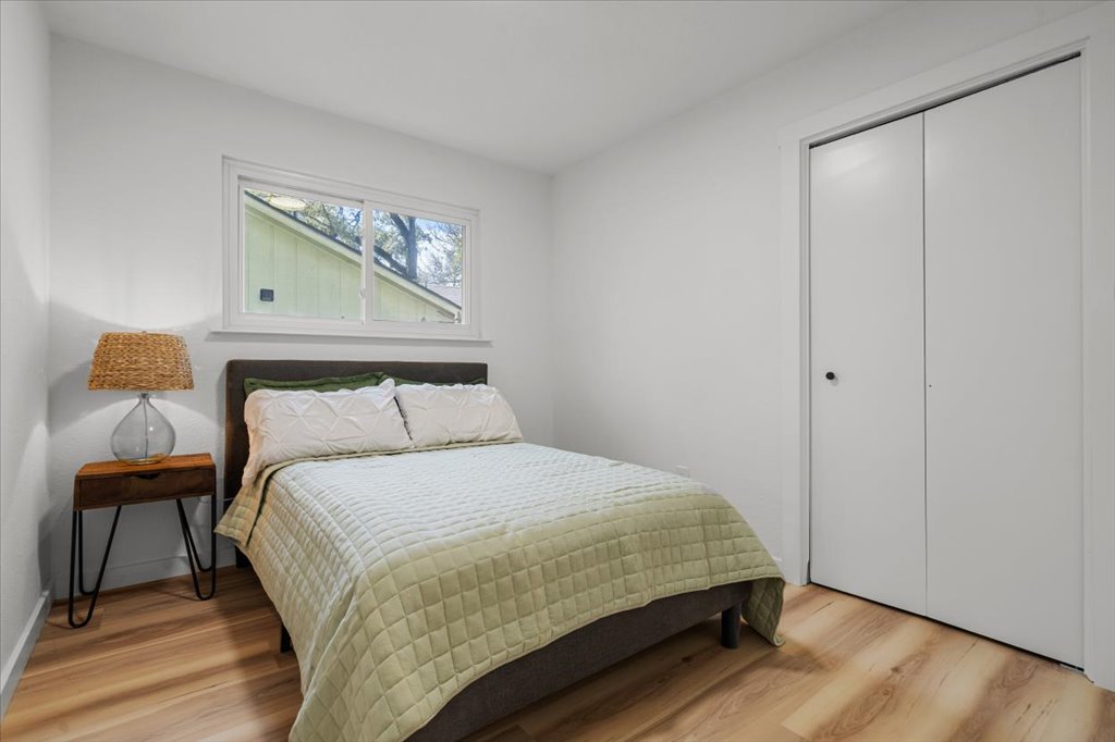 9223 Independence Loop Austin, TX 78748 - Photo 28 of 37 a bedroom with a bed and wooden floor