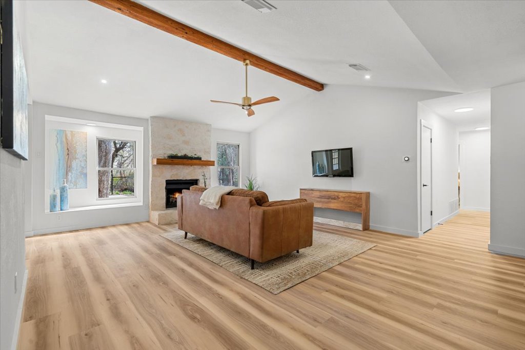 9223 Independence Loop Austin, TX 78748 - Photo 7 of 37 a living room with furniture a fireplace and a flat screen tv