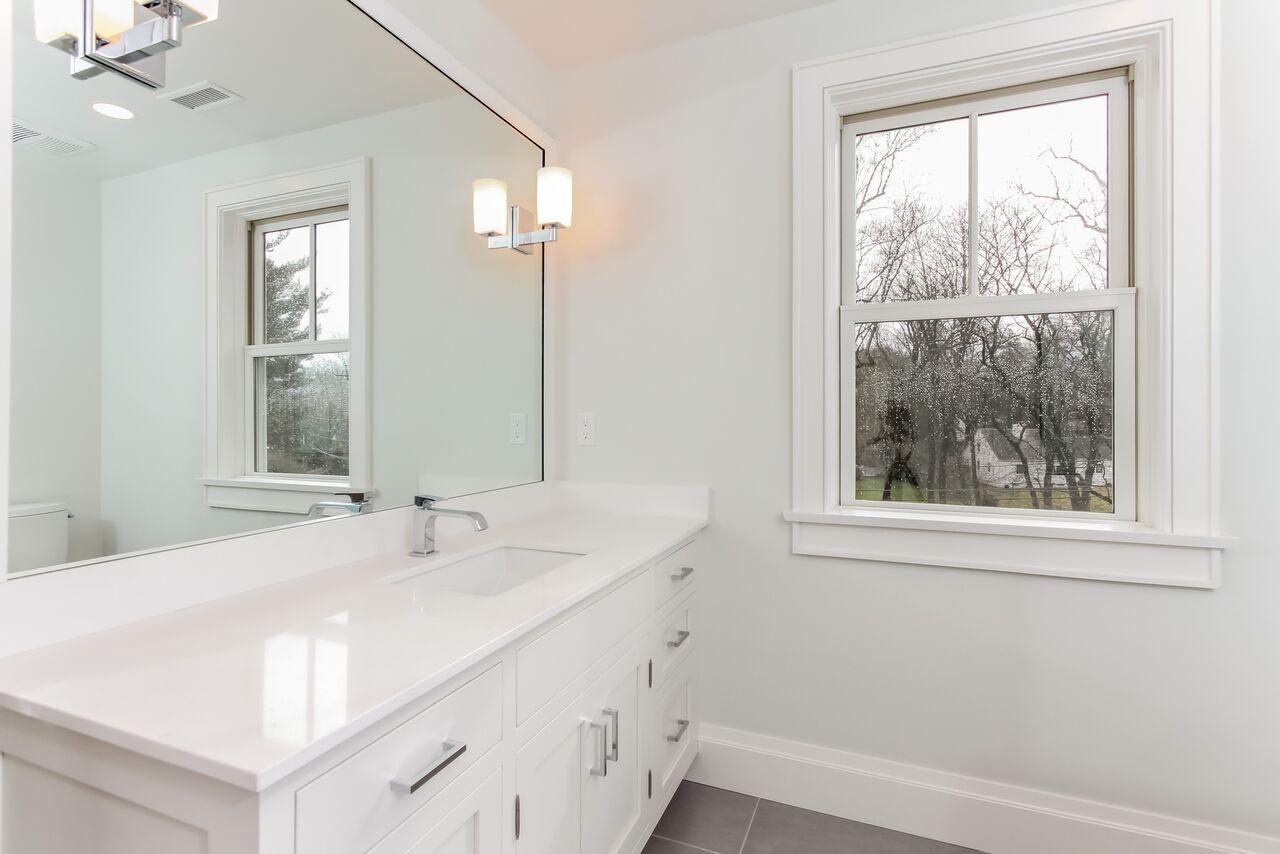 7 Indian Spring Road Rowayton, CT 06853 - Photo 25 of 28 a bathroom with a sink and a window