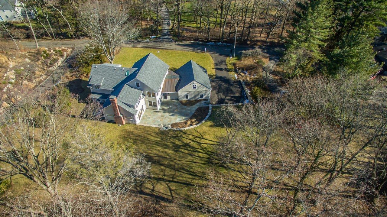 7 Indian Spring Road Rowayton, CT 06853 - Photo 3 of 28 a aerial view of a house with swimming pool and large trees