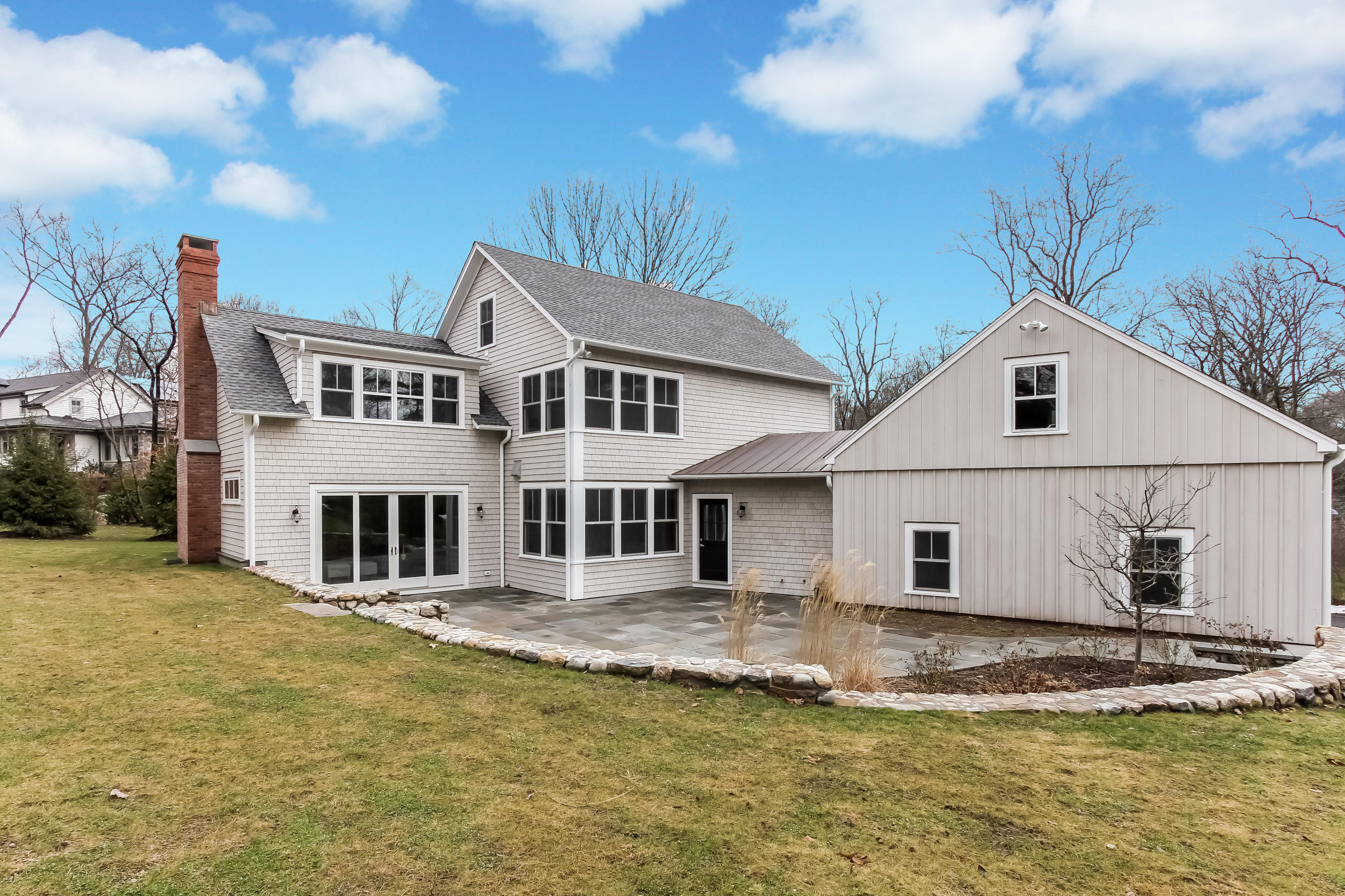 7 Indian Spring Road Rowayton, CT 06853 - Photo 6 of 28 a view of a white house with a large pool lawn chairs and a small yard